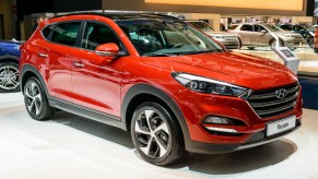 A red Hyundai Tucson is on display.