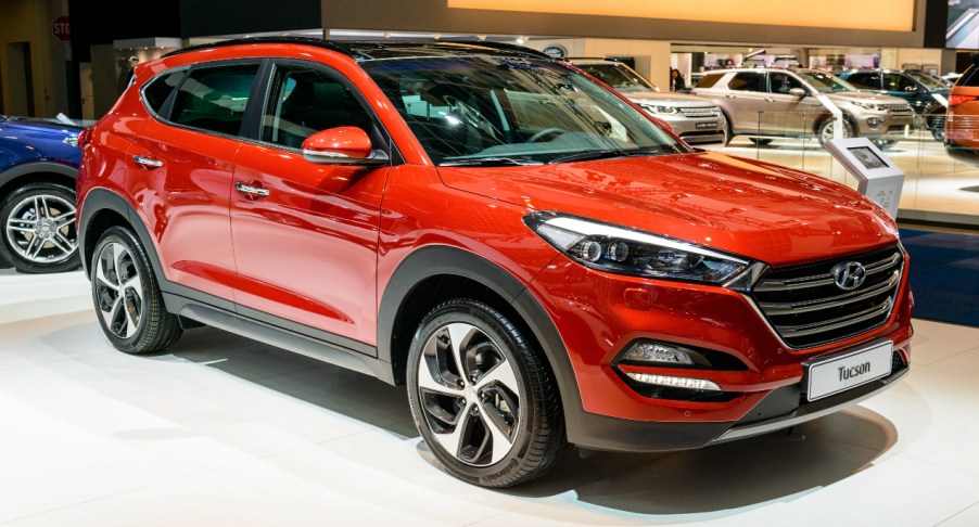 A red Hyundai Tucson is on display.