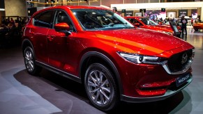 A red Mazda CX-5 is on display.