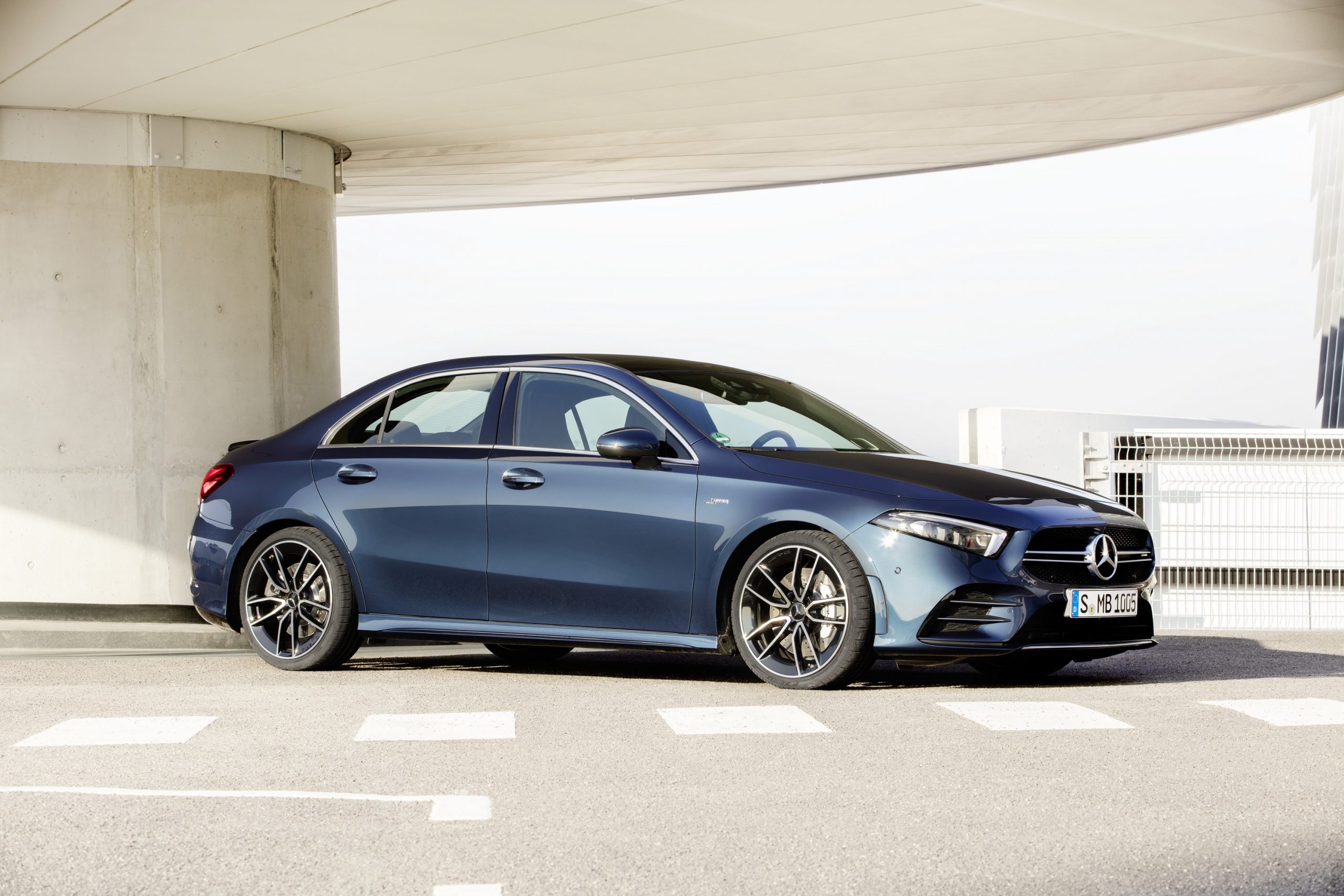 A blue Mercedes-Benz AMG A35 sedan shot from the front 3/4