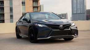 Midnight Black Metallic 2022 Toyota Camry parked on the roof of a building