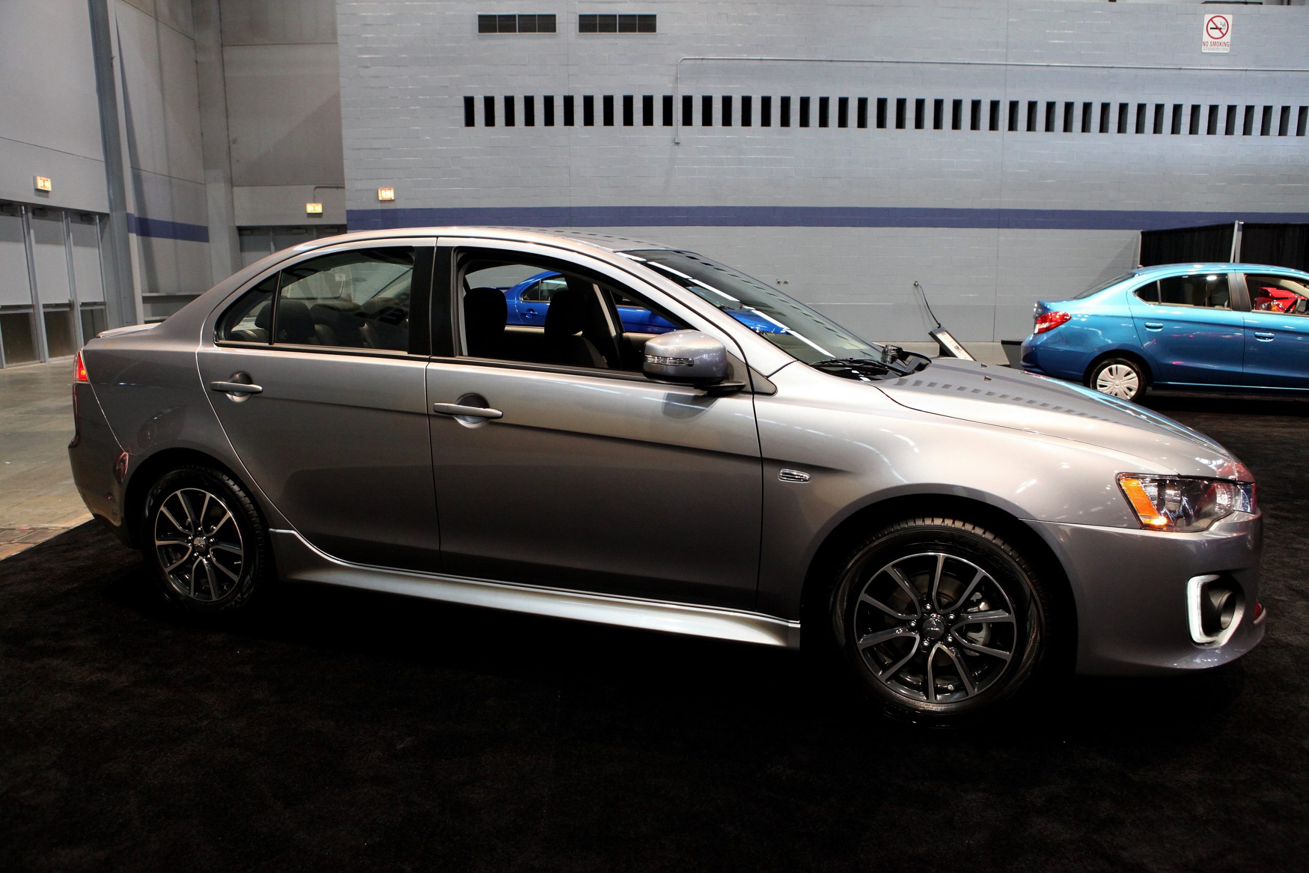 A silver Mitsubishi Lancer sedan shot in profile