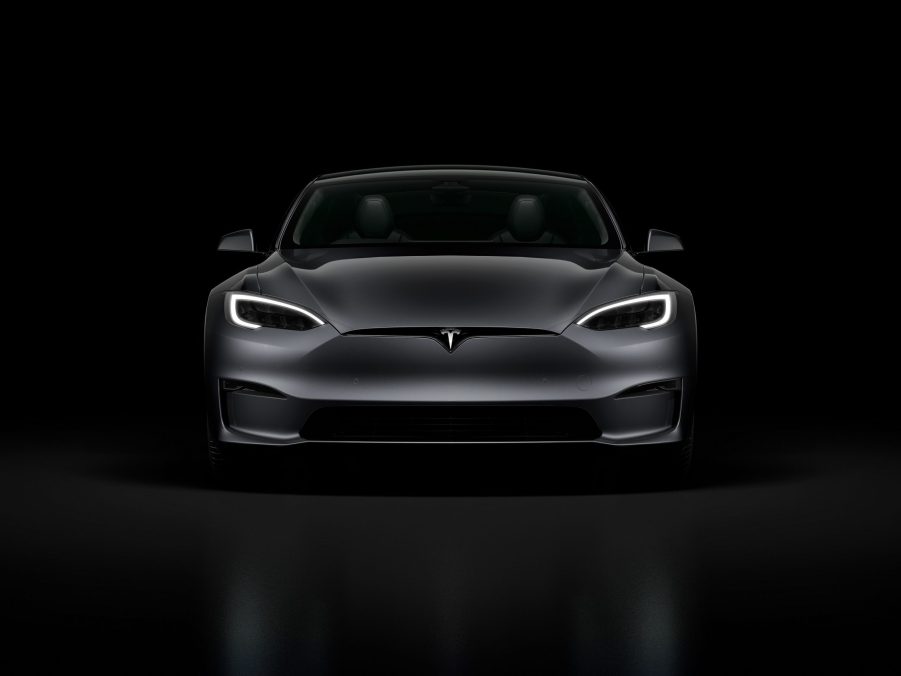 A grey 2022 Tesla Model S Plaid surrounded by shadow in a photo booth