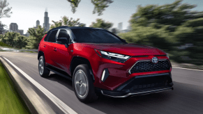 Passenger's side front angle view of Supersonic Red 2022 Toyota RAV4 Prime