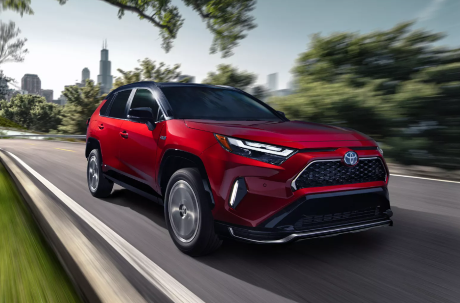 Passenger's side front angle view of Supersonic Red 2022 Toyota RAV4 Prime