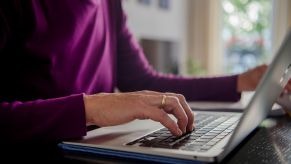 Person online potentially shopping wearing a purple shirt.