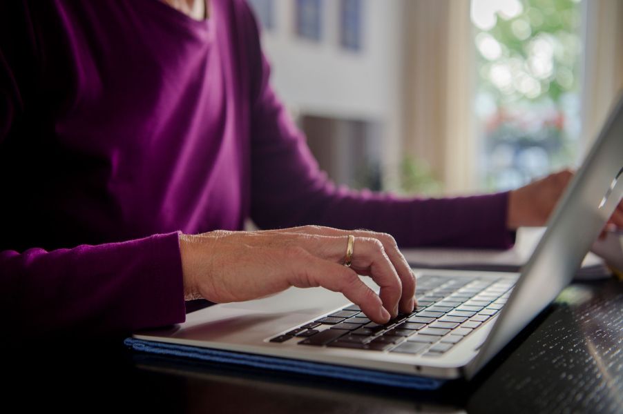 Person online potentially shopping wearing a purple shirt.