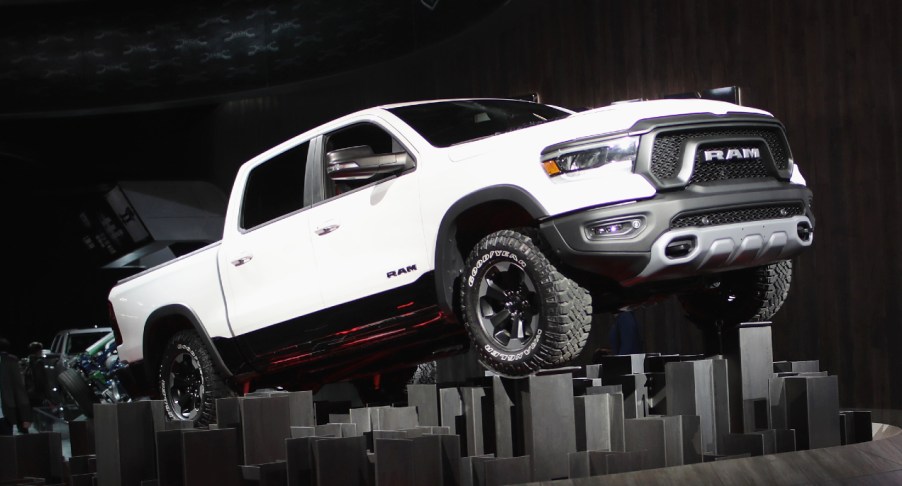 A white Ram 1500 full-size pickup truck is on display.