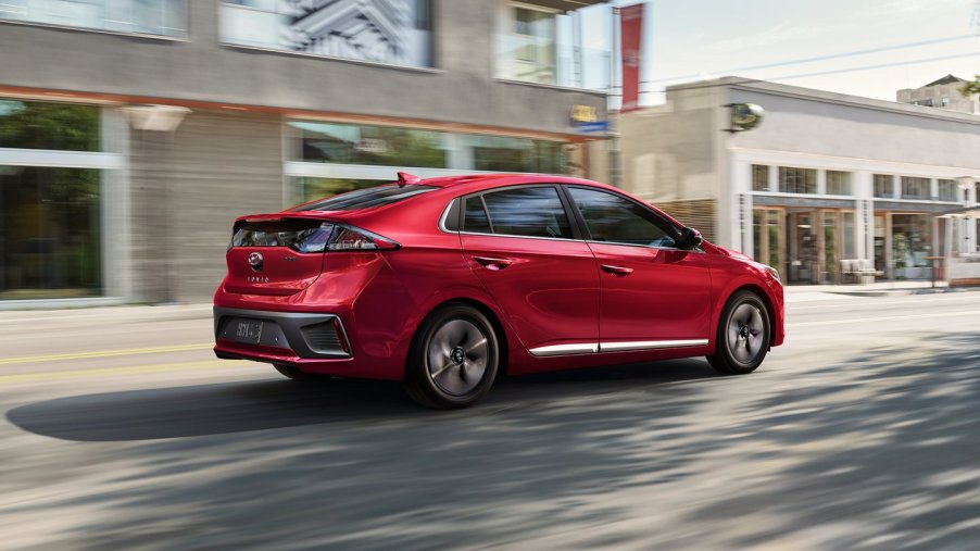 Red 2022 Hyundai Ioniq Hybrid, a good non-EV car to save money on gas, driving on a city street