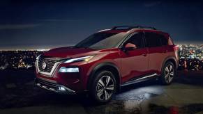 Red 2022 Nissan Rogue with a city skyline in the background