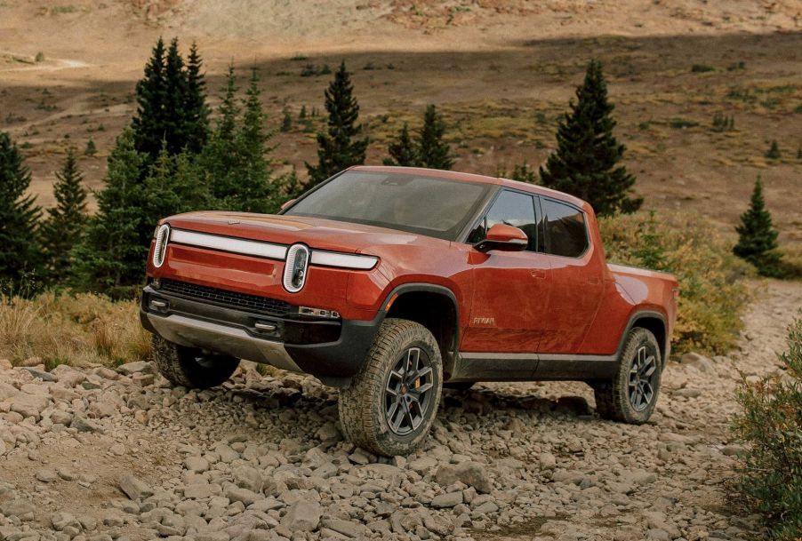 Red Canyon 2022 Rivian R1T driving on a rocky path, showing off its one huge advantage over other EV trucks