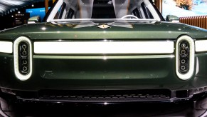 A green Rivian R1S electric SUV model.