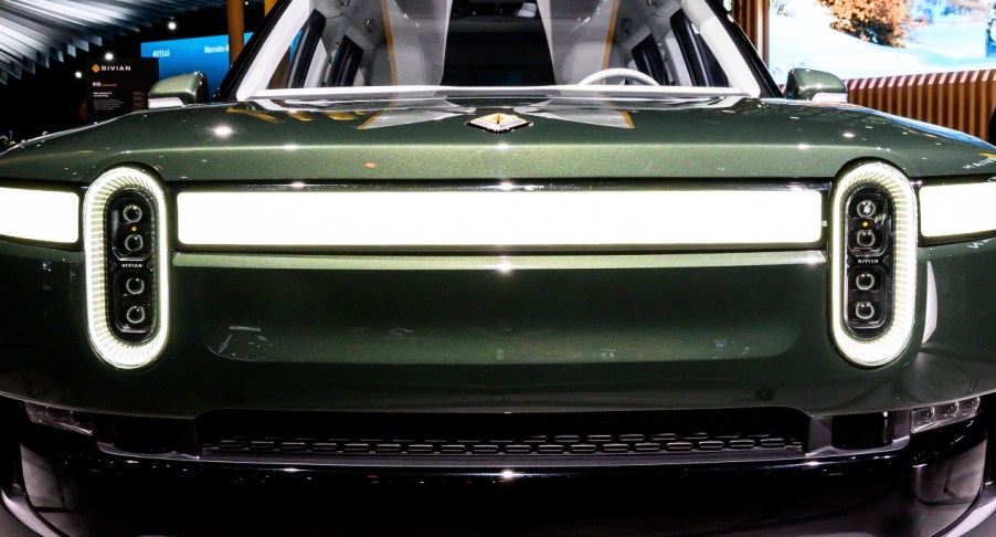 A green Rivian R1S electric SUV model.