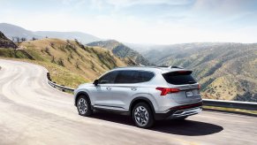 Shimmering Silver 2022 Hyundai Santa Fe Plug-in Hybrid PHEV driving on a mountain road