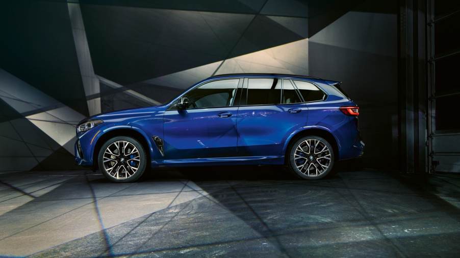 Side view of a fully loaded new blue 2022 BMW X5 M