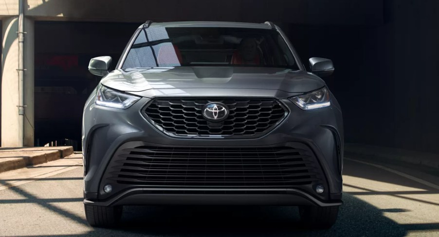 A silver 2022 Toyota Highlander against a black background.