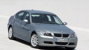 A silver used 2008 BMW E90 328i sedan on a garage rooftop