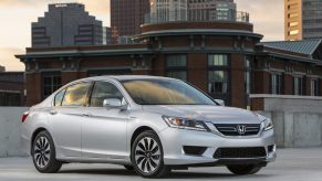 A silver used 2014 Honda Accord Hybrid EX-L sedan on a rooftop garage