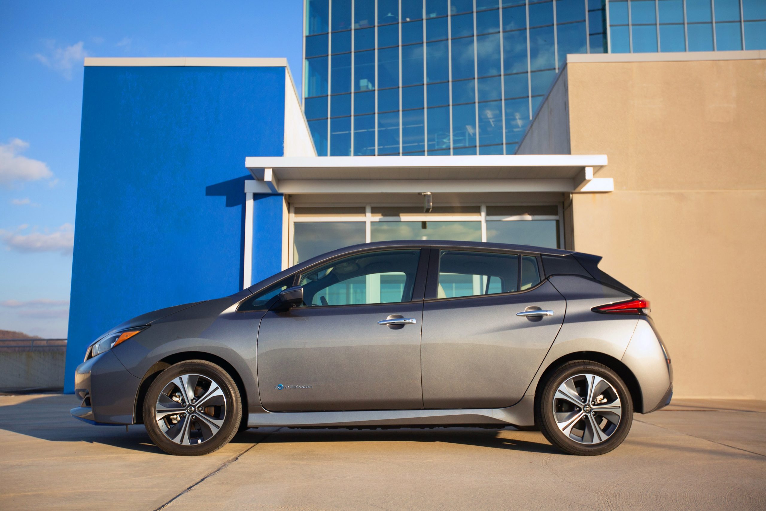 A grey 2022 Nissan Leaf hatchback shot in profile