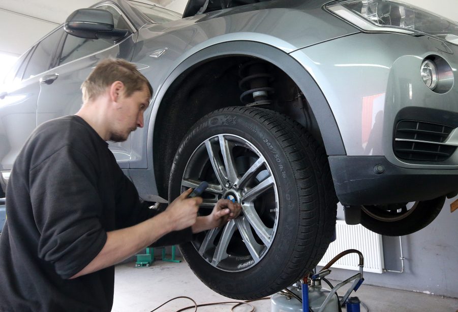 a mechanic replacing tires