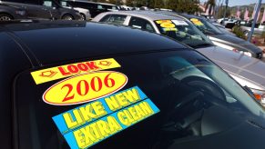 a used car for sale with stickers on the windshield