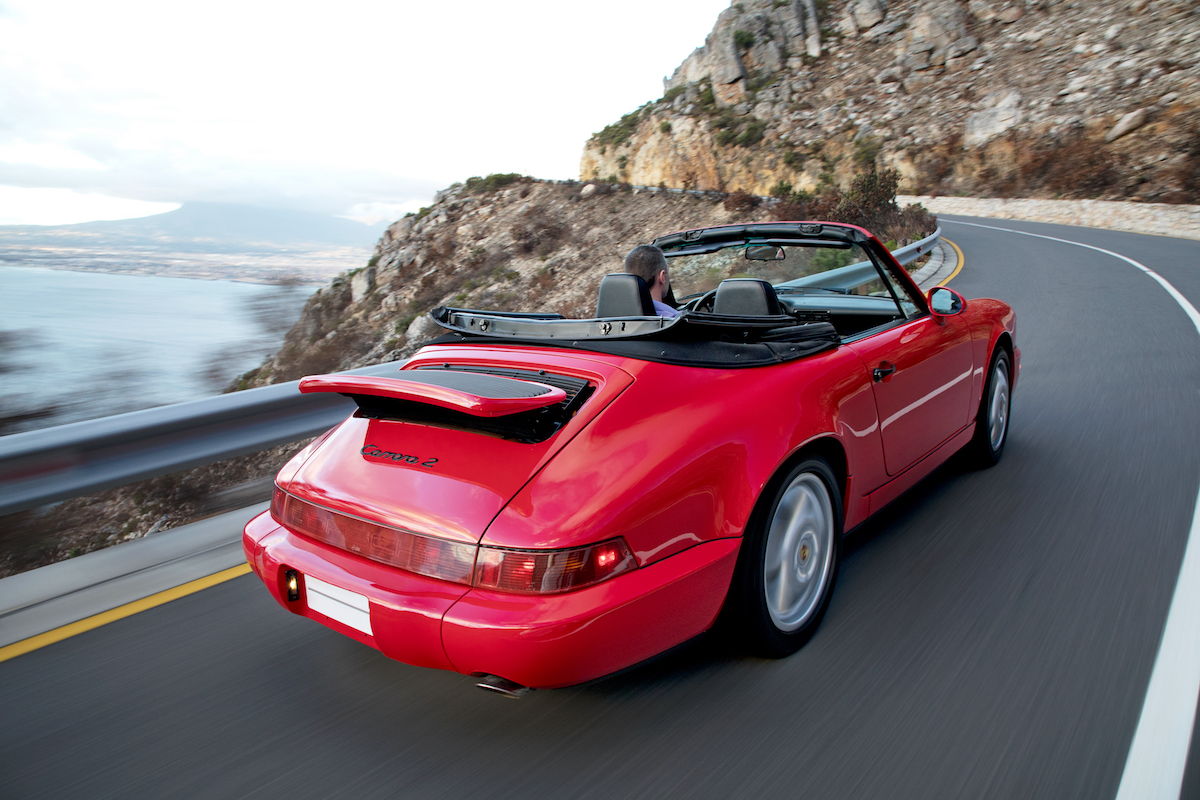 A 1990 Porsche 964 Carrera 2 Cabriolet sports car on a mountain in South Africa in 2018