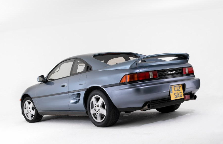 A light-blue 1992 Toyota MR2 parked in a white room