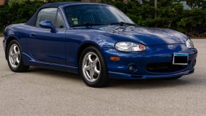 A blue 1999 NB Mazda MX-5 Miata 10th Anniversary Edition in a parking lot