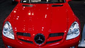 The front view of a red 2009 Mercedes SLK 55 AMG at a car show