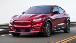 A red 2021 Ford Mustang Mach-e on the road.