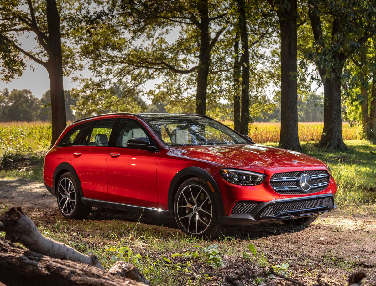 A 3/4 front view of a red Mercedes-Benz E450 4MATIC All-Terrain on a dirt road.