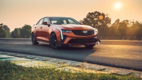 An orange 2022 Cadillac CT4-V Blackwing with optional Carbon Packages on a racetrack