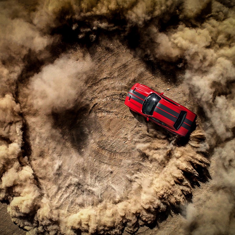 Dodge is looking for the 2022 Dodge Chief Donut Maker. This photo shows a Hellcat ripping a donut in the dirt.