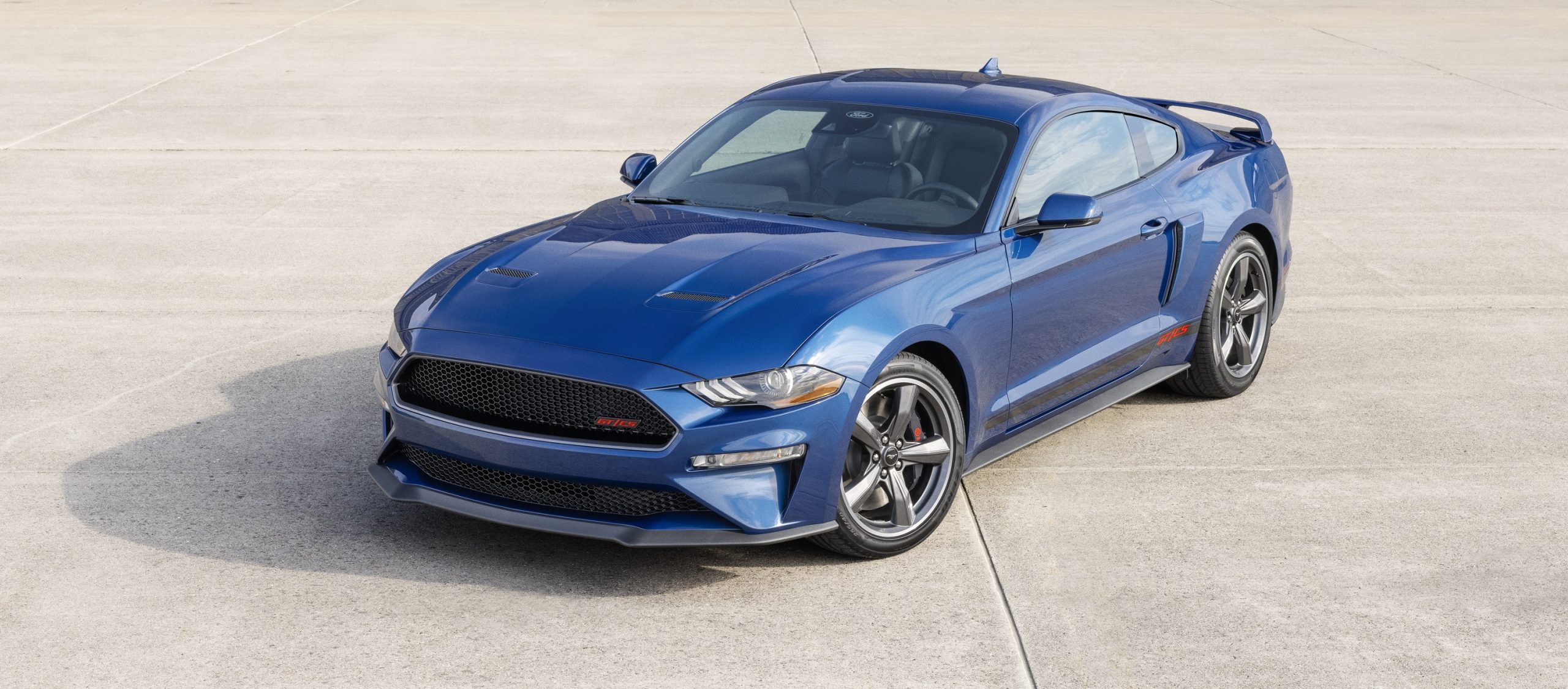 A blue 2022 Ford Mustang GT shot from the front 3/4