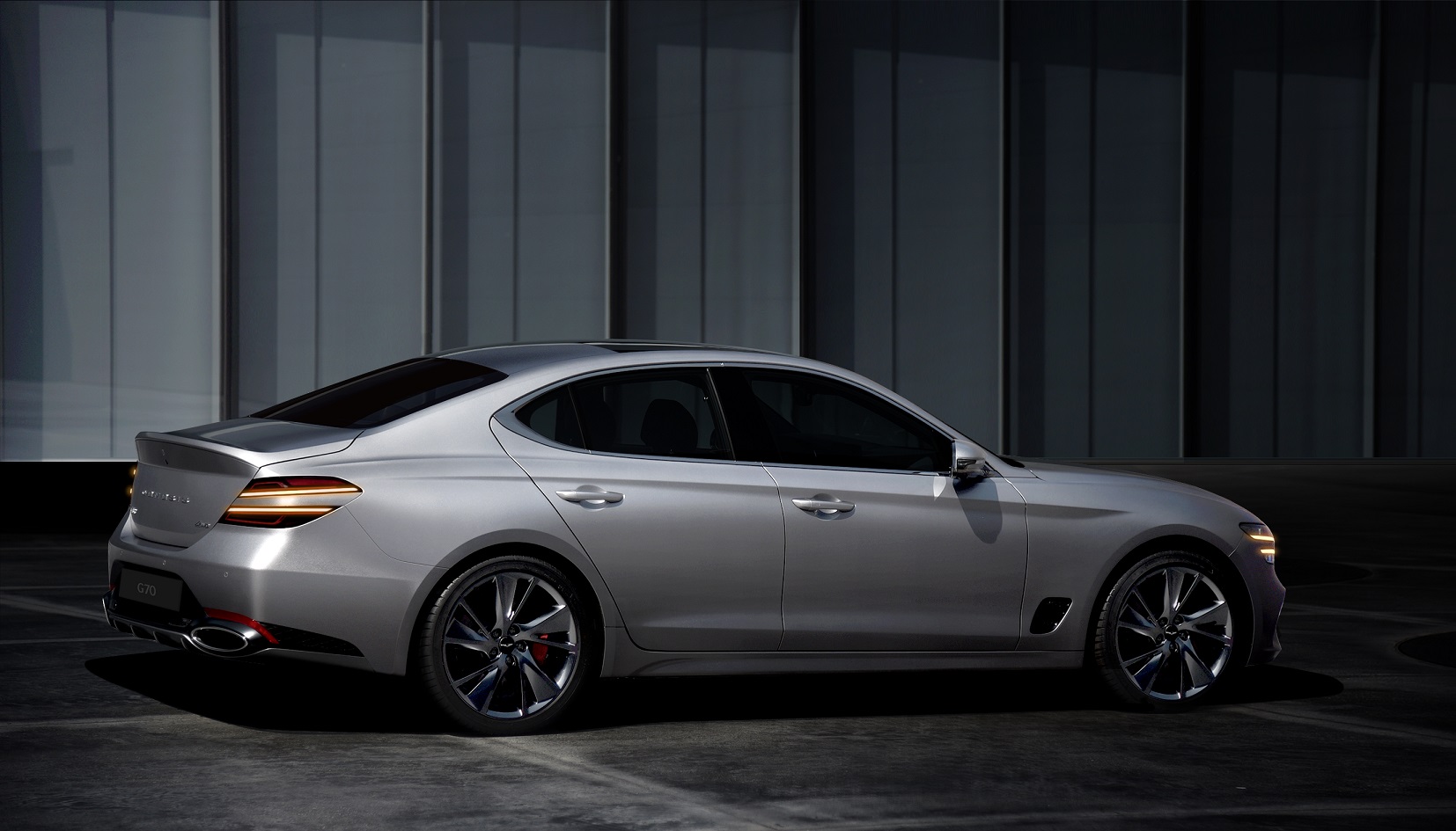 A rear 3/4 shot of the 2022 Genesis G70 in silver