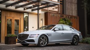 A white 2022 Genesis G80 parked in front of the Hotel San Luis Obispo