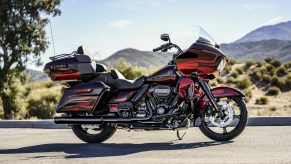 A red-and-black-flame 2022 Harley-Davidson CVO Road Glide Limited on a desert road