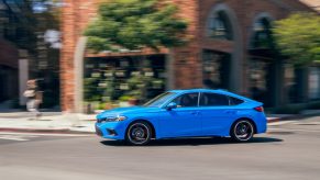 A blue 2022 Honda Civic hatchback with a manual transmission shot from the front 3/4