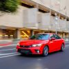 A red 2022 Honda Civic sedan shot on a city street