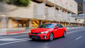 A red 2022 Honda Civic sedan shot on a city street