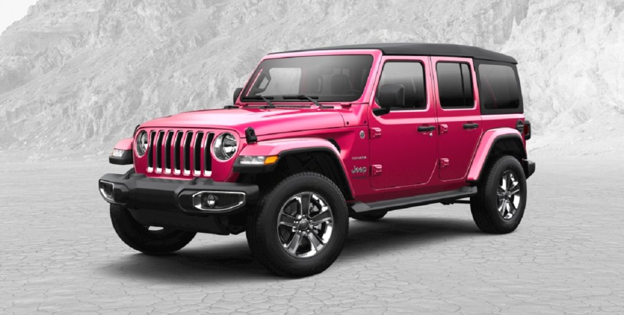 A pink 2022 Jeep Wrangler against a gray background.