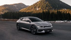 A 2022 Kia EV6 in a wooded mountainous environment on blacktop.