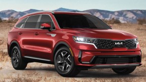 A red 2022 Kia Sorento Hybrid is parked outdoors.