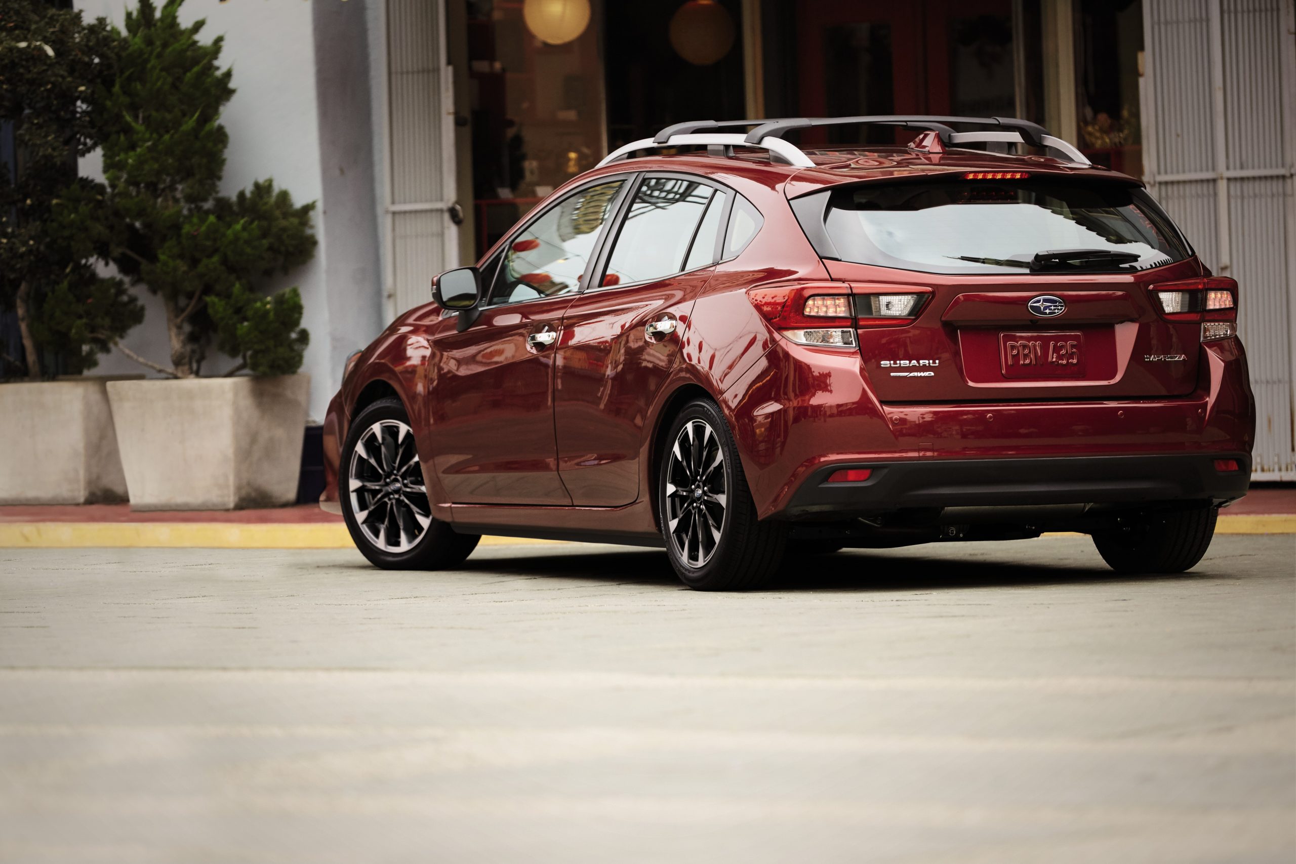 A red 2022 Subaru Impreza wagon shot from the rear 3/4