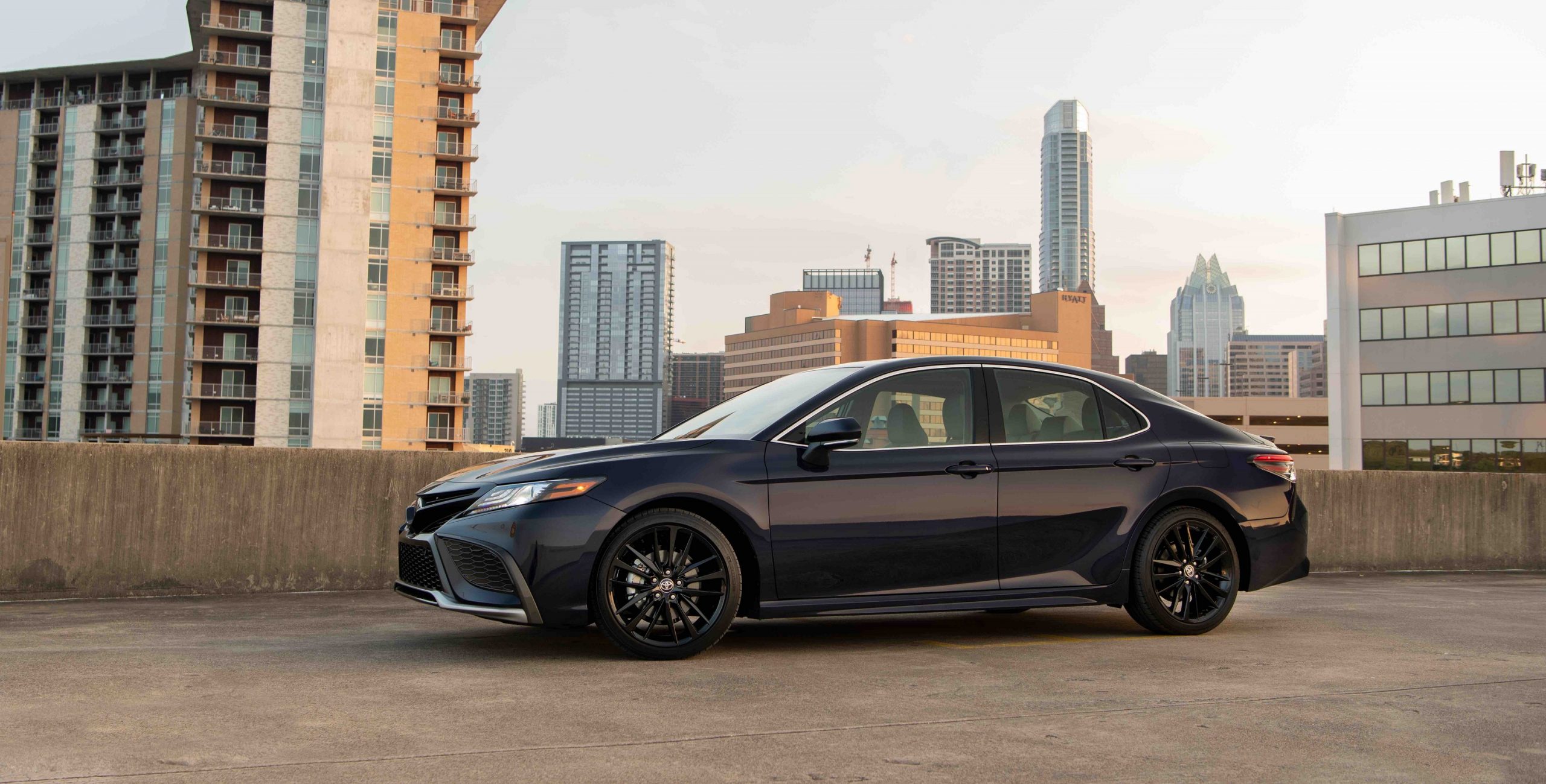 A black 2022 Toyota Camry shot in profile