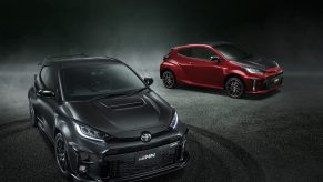 A gray 2022 Toyota GRMN Yaris Circuit Package next to a red one with the Rally Package