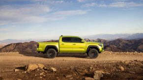 A lime green 2022 Toyota Tacoma TRD Pro parked on gravel overlooking mountains