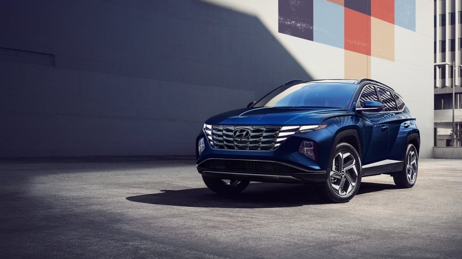 A dark blue 2022 Hyundai Tucson Hybrid in the city.