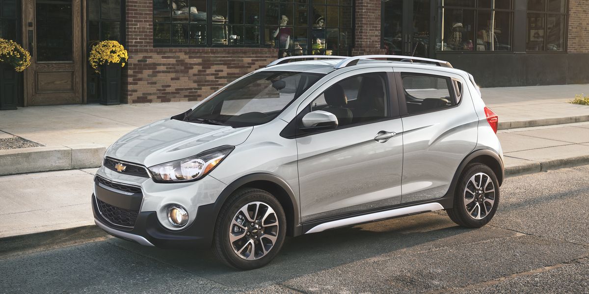 A silver 2022 Chevrolet Spark Activ parked along a street. 