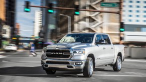 A white 2022 Ram 1500 parked in a city.